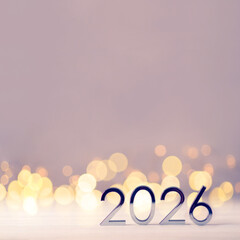 Metal numbers 2026 on a white table with Christmas trees and bokeh lights. Happy New Year 2026 is coming concept.