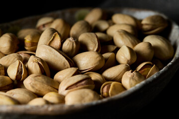  Close up view pistachios in a old bowl
