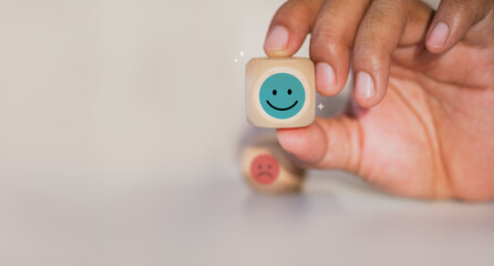 Fototapeta premium Mental health day or Positive feedback concept. Online client service review. Satisfaction survey. excellent experience. Emotional icons on wood cube. Good rating and evaluation. Positive thinking