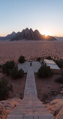 Desert vista at sunrise, stone path leading to structures