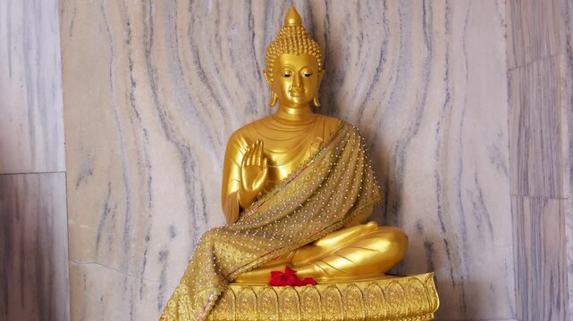 pristine sacred golden buddha statue in holy position at monastery