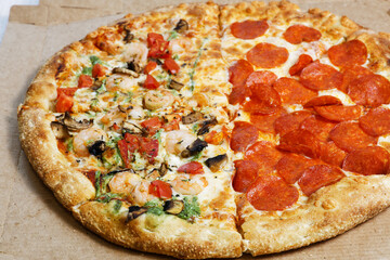 Closeup assorted pizza from cardboard box. Shallow focus.