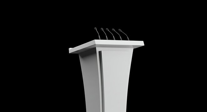 A white podium with three microphones stands against a stark black background, ready for a speaker.