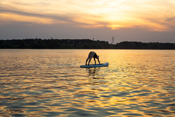 Woman exercising yoga together Poses with Sub board or Stand up Paddle board
