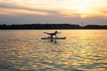 Woman exercising yoga together Poses with Sub board or Stand up Paddle board