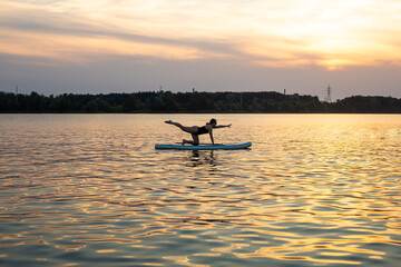 Woman practicing yoga Poses with Sub board or Stand up Paddle board