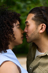 Young couple sharing a tender moment of intimacy outdoors