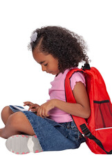 Smiling and thoughtful face schoolgirl, ethnic, smart in school clothes, sitting. Holds a tablet on...