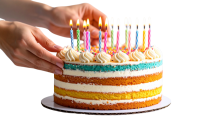 Close-up of hands lighting birthday candles on a vibrant, multi-layered cake isolated on solid white background in Png