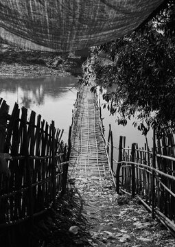 Suspended wooden bridge over a river, Inle lake, Myanmar
