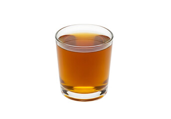 Close-up of a clear glass shot glass filled with amber liquid.