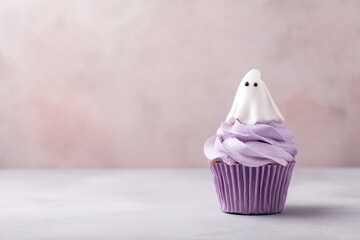 Halloween Cupcake with Ghost Topper and Purple Frosting on Pink Background.