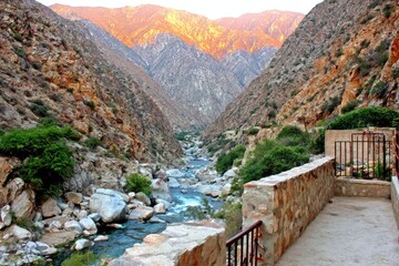 Mountain canyon with river, stone wall and path
