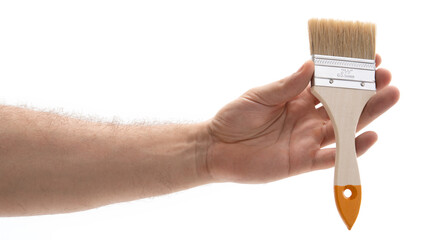 Hand with paintbrush for home projects