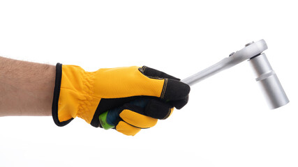 Hand holding a ratchet tool in protective gloves