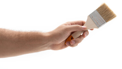 Hand holding a paintbrush ready for creative work