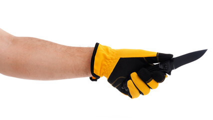 Hand holding a black knife with yellow gloves