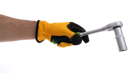 Hand holding a socket wrench with a yellow glove