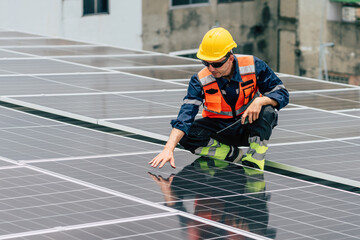 Solar panel technician inspecting photovoltaic system on rooftop in urban area during daylight