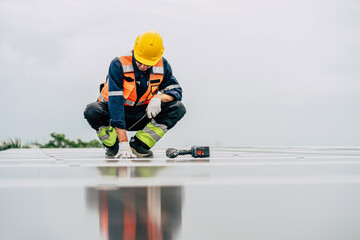 Worker inspects solar panels on rooftop while wearing safety gear and using tools