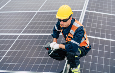 Solar panel technician performs installation on rooftop during bright sunny day