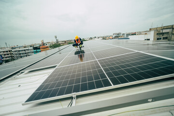 Worker installing solar panels on a rooftop in an urban setting during overcast weather