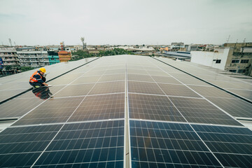 Worker installing solar panels on rooftop in urban setting during overcast afternoon