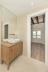 Minimalist bathroom with wall-mounted circular porcelain sink, invisible faucets, and tempered glass shower enclosure