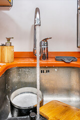 Utensils as silent witnesses to our haste, waiting patiently under the redeeming stream
