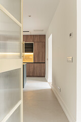 Modern kitchen with industrial style: exposed brick, vintage lighting, and high-end appliances