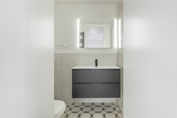 Contemporary bathroom with a wall-mounted porcelain sink, a wall-mounted mixer tap with eco...
