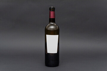 Minimalist composition of a solitary wine bottle on a matte black background that enhances its...
