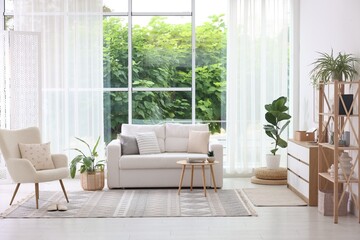 Stylish sofa and other furniture in living room. Interior design