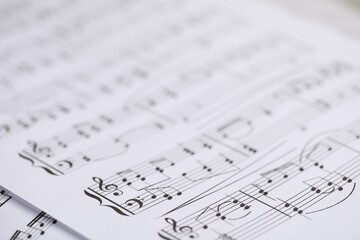 Sheets with musical notes as background, closeup