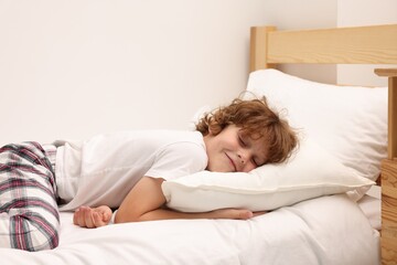 Little boy sleeping in bed at home