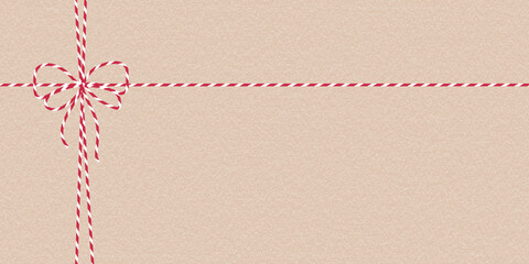 Eco craft Xmas background with red white twine bow. Paper texture. Festive template for greeting card, packaging, DIY tag, holiday print design, Christmas New Year banner, poster, invitation, ads