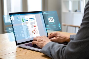 Young businessman analyzing data on laptop, futuristic interface, modern office, serious mood, professional attire.