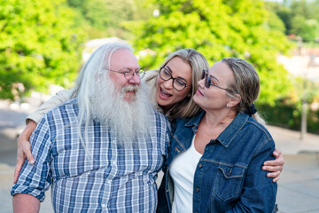Fototapeta premium Family members enjoying a warm moment outdoors in a green park during a sunny day while capturing a cherished memory