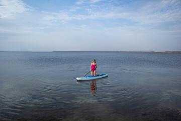 Woman on Stand Up Paddle Board in Calm Lake. Summer Water Sport, Outdoor Adventure, Peaceful Nature...