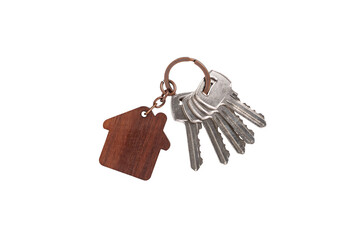 Bunch of metal door keys with keychain in the form of wooden house on bronze chain isolated on white background