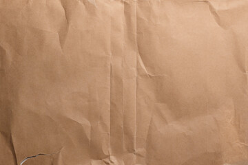 Aged creased wrunkled brown wrapping paper texture with old worn folds. Abstract vintage background