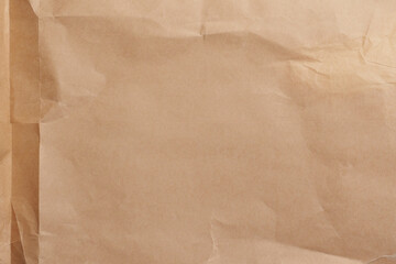 Old used parchment paper. Brown crumpled folded vintage aged surface. Abstract textured background