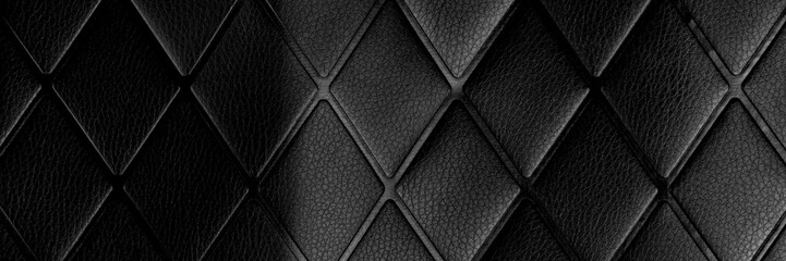 Black rhombic crumpled leather. Dark abstract surface with geometric pattern. Textured background