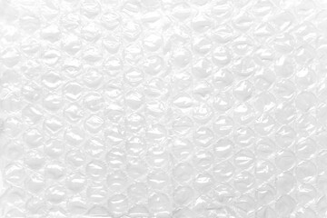 Transparent packaging bubble wrap on white table. Abstract background. Soft protective material
