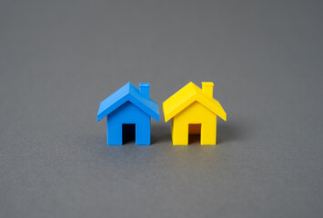 Houses in the colors of the Ukrainian flag. Care and support for Ukrainian refugees. Restoration of...