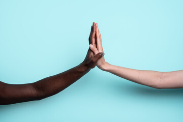 Unity through multiethnic hands touching on blue