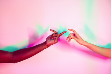 Multiethnic hands reaching across colorful background