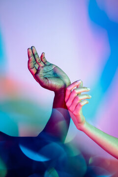 Multiethnic hands in vibrant gradient colors