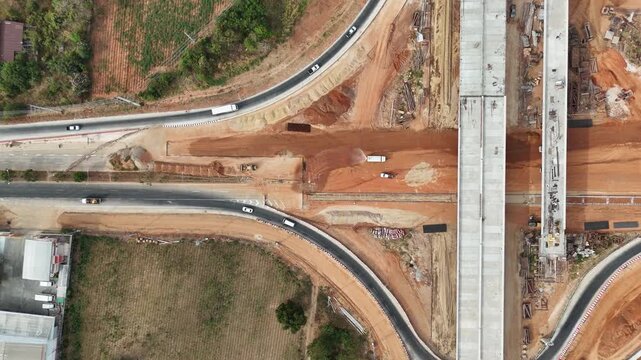Aerial view drone footage of bridge construction being made across the intersection