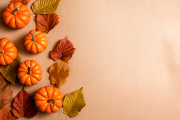 Bright orange pumpkins and autumn leaves arranged on a neutral background for seasonal decor and celebration